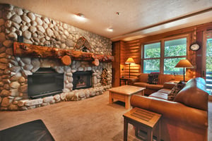 Spacious living room with 2 leather couches and wooden coffee table