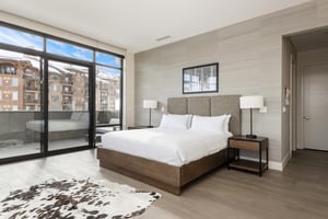 Luxurious king bed, wooden platform bedframe, hardwood floors and cowhide area rug