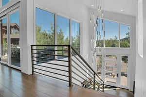 Vacation rental stunning entry way with large windows and a unique modern chandelier..