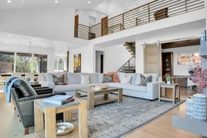 Vacation rental living room with wooden coffee tables and end tables and comfortable seating.