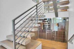 Vacation rental wine storage underneath the floating stairs.