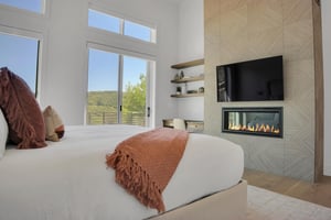 Vacation rental main suite with built in gas fireplace and flat screen TV.