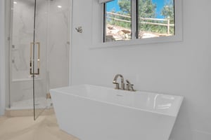 Vacation rental en suite bathroom with free standing deep soaker tub and walk in shower.