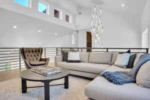 Vacation rental second living room with sectional sofa, club chair, and coffee table.
