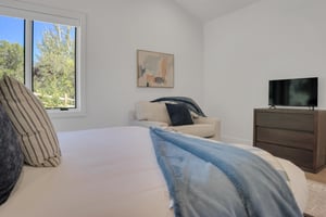 Vacation rental bedroom with cozy additional seating.