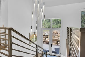 Vacation rental back entry with stunning chandelier and glass doors.