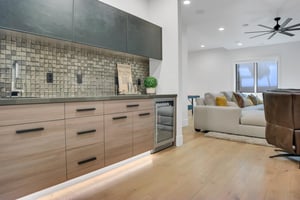 Vacation rental game room with a built in wet bar and mini fridge.
