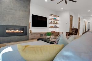 Vacation rental game room with large sectional sofa and built in storage.