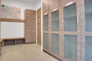 Vacation rental built in cabinets for ski storage, long bench seating and wall hangers.