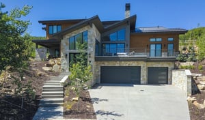 Vacation rental entry with a heated driveway leading to the three car garage and and steps leading to the entry door.
