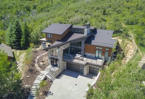 An ariel view of the vacation rental surrounded by the mountainside and oak grove and aspens.