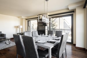 Square dining room table fully set with seating for 8
