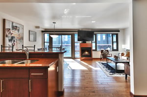 Open floor plan, kitchen leads to the dining room and living room with the granite surround fireplace in the center