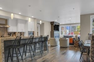 Rio Grande 202 has an open concept kitchen and living room and the kitchen island has four black barstools.