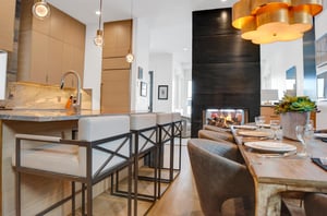 The kitchen has a cozy dual facing fireplace, table with seating for 8 and island with seating for four.