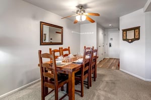 Snow Flower 12s dining areas has a solid wood table, 6 wood chairs, and is fully set with glassware, placemats, etc