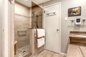 Snow Flower 29s en suite bathroom with well designed griege tile work on the floor and in the walk in shower.