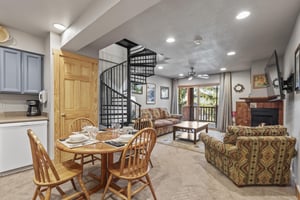 Snow Flower 72s dining area sitting next to a the living room with a cozy couch and love seat.
