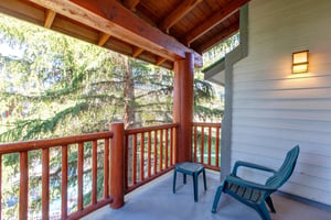 Enjoy your own private patio with two green chairs to relax in.
