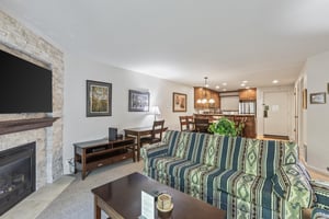 Snow Flower 135s living room with southwestern upholstered couch and the open concept dining room.