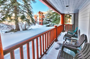 Private patio overlooks pine trees and the tennis courts
