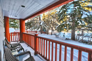Private patio overlooks pine trees and the tennis courts