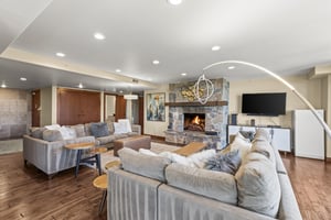 Lowell 401 has a spacious living area with two large sectional sofas and gas fireplace with floor to ceiling stone surround.