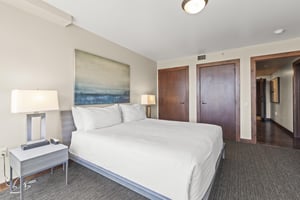The third bedroom has a king size bed with crisp white linens and well appointed furniture and art.