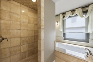 The second bedrooms en suite bathroom has a walk in shower and deep jetted tub.