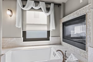 The second bedrooms en suite bathroom has a fireplace above a deep jetted tub.