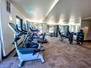 Lowell fitness center stationary bikes, treadmill, and Peloton