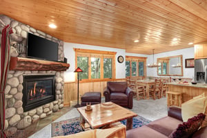 Timber Wolf Lodge 10 D has a cozy living room with a wood coffee table and leather chair and footrest.