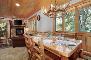 Timber Wolf Lodge 10 Ds dining area with wood table set for 6, seating for 6 and a lovely table next to it.