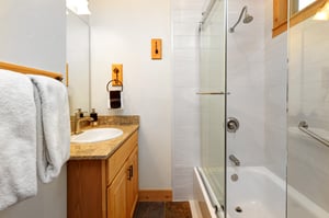 The second bedroom has an en suite bathroom with a bathtub and shower combination.