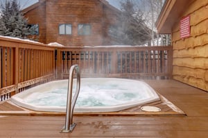 Timber Wolf Lodge 10 D has hot tub steps away from the home which is shown in the background.