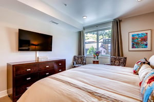 Main bedroom king bed large screen TV  ParkCityLodging_820ParkAve204_MainBed_2