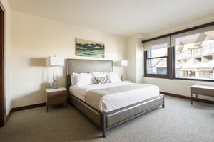 Expansive main bedroom suite with leather headboard