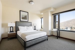 Guest bedroom, queen bed with white linen and accent coverlet