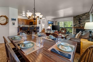 The dining room table offers seating and place settings for six guests.