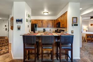 The kitchen includes gorgeous wood cabinets and stainless steel appliances