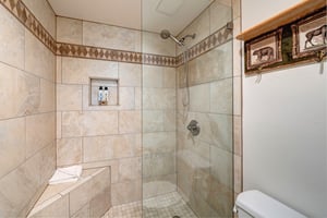 The main suite bathroom has a tiled walk in shower.