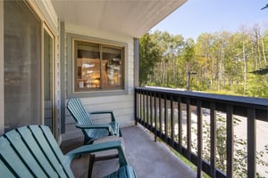 The private balcony has large sliding glass doors and seating to take in the view.