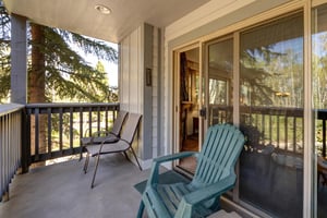 The private balcony has large sliding glass doors and seating to take in the view.