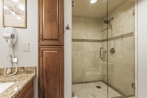 Snow Flower 135s en suite bathroom with walk in tiled shower, built in wooden cabinets and granite vanity.