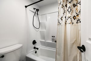 Combo bath tub shower in the main bathroom with adjustable shower head