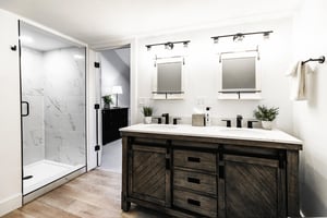 Loft bathroom with dual vanity, barn wood cabinetry and walk in shower