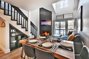 Dining room table overlooking the wood burning fireplace and living room