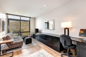 A den with an office, flat screen TV and queen sleeper sofa.