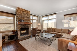 Lowell 402 living room with blinds lowered with gas burning fireplace.