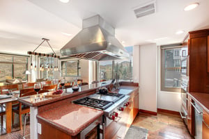 Lowell 402 kitchen island with range and stainless steel range hood.